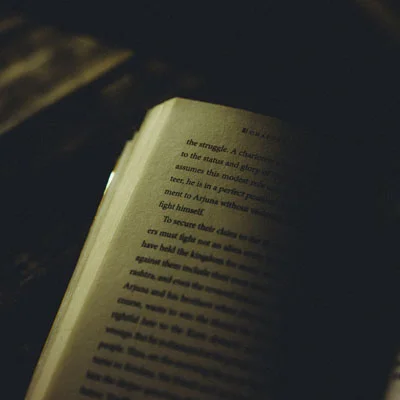 book in dark with a candel light  